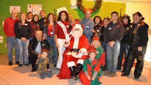 Miss Lakes Region Outstanding Teen and members of the Manchester Harley Owners' Group Chapter 1294 celebrate Christmas with students at Spaulding Youth Center