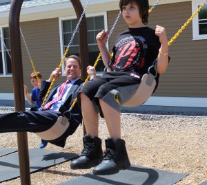 Frank Edelblut swinging with Spaulding Youth Center Kids