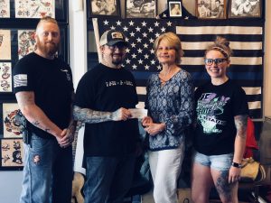 Spaulding Youth Center Receives Donation from Pair-A-Dice Tattoo Company